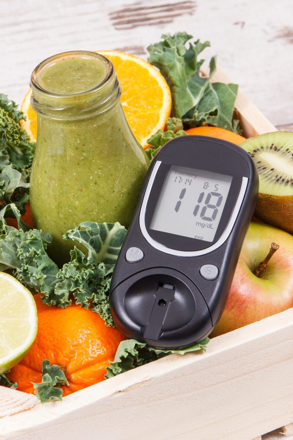 Glucose meter with sugar level and freshly blended coctail from fruits and vegetables